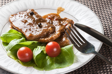 Pork chop with sauce and vegetables