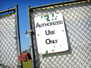 authorized use only sign with locked fence