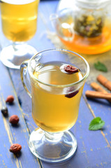 Dog-rose tea on blue background 