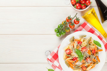 Colorful penne pasta with tomatoes and basil