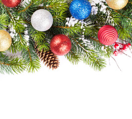 Obraz na płótnie Canvas Christmas tree branch with snow and baubles