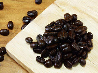 studio shot of coffee beans on wooden background still life