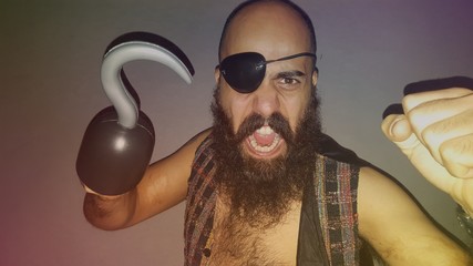 angry pirate masked bearded man on gray background - halloween and carnival concepts