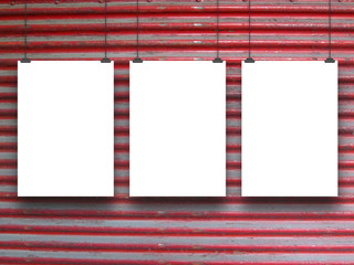 Three white paper sheets with clips on dirty red shutter