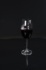 re wine glass on black background