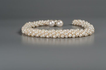 pearl necklace on gray background