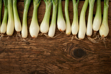 fresh onions on wooden kitchen table