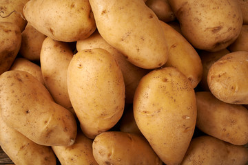 many potato on wooden kitchen table