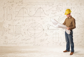 Handsome engineer calculating with hand drawn background