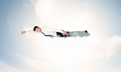 Business man flying like a superhero in clouds on the sky