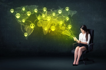 Businesswoman in office with tablet and social network world map