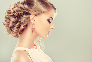 Beautiful model with  elegant hairstyle . Beautiful woman with fashion wedding hairstyle and colourful makeup
 - obrazy, fototapety, plakaty