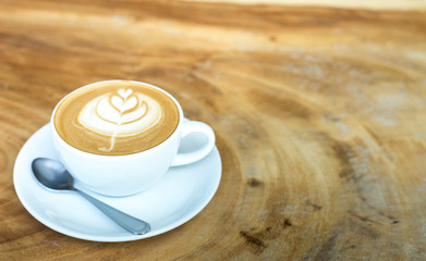 Hot art Latte Coffee in a cup on wooden table and Coffee shop bl