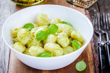 homemade gnocchi with pesto sauce, parmesan and basil