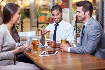  businessman sitting at restaurant and celebrating success with