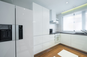 Interior of a modern luxury bright white kitchen