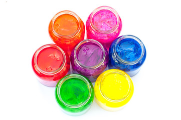 Jars full of colour/ Jars of coloured tissue paper in water, arranged in a circle