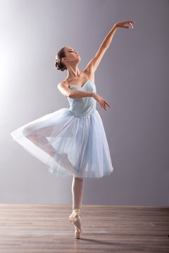 Fototapeta young ballerina in ballet pose classical dance
