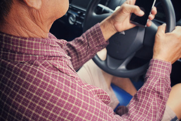 Fototapeta premium Man using smart phone in the car.