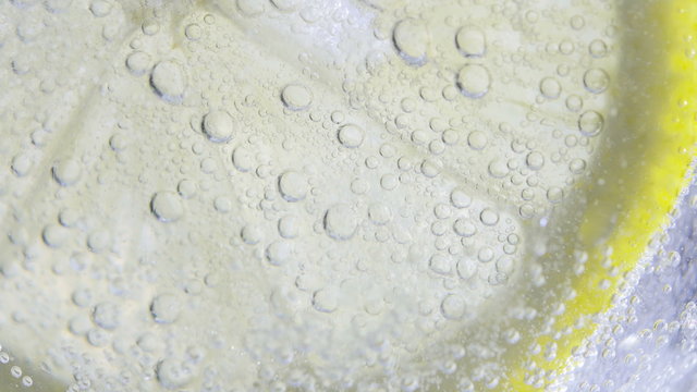 Lime slice in soda water. Macro close-up 4K UHD 2160p footage.
