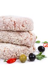 three raw cutlet with breading from on side