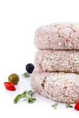 three raw cutlet with breading from on side