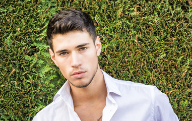 Handsome young man in elegant business suit standing outdoor 