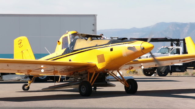 Yellow crop duster aircraft being loaded with seeds HD 3443
