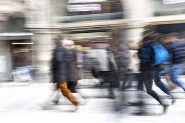 Blurred pedestrian walking, zoom effect