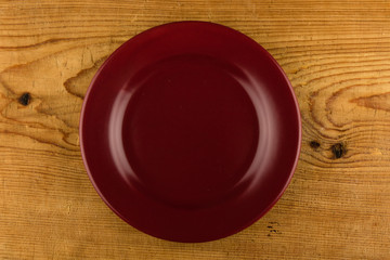 red plate on wooden table