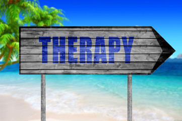 Therapy wooden sign with a beach on background