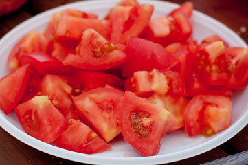Tomato slices on white plate