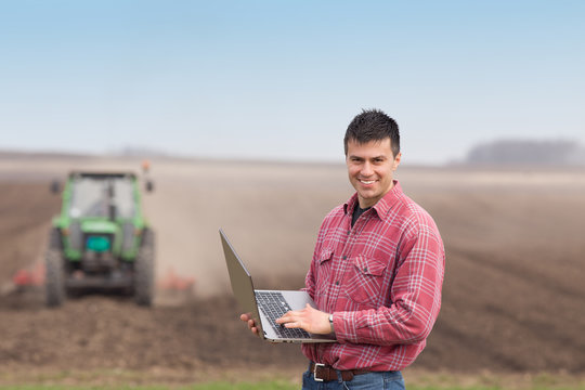 Farmer with laptop in the field