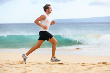 Fitness sports runner man jogging on beach