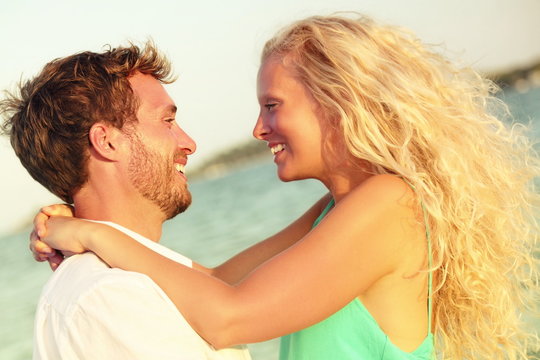 Romantic couple in love kissing happy at beach