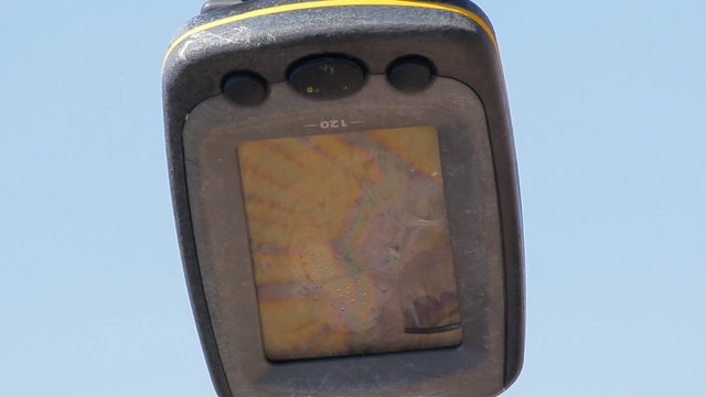 On rest of broken mast swaying sea GPS. On screen rays of sun