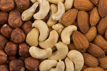 Obraz premium mixed nuts background above closeup