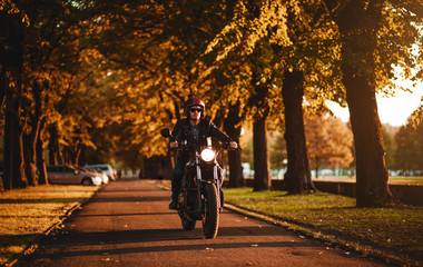 Man riding a cafe-racer motorcycle outdoors
