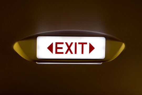 exit sign in a plane in the dark environment