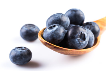 Fresh blueberries in wooden spoon