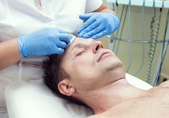 man in a beauty salon facial and massage