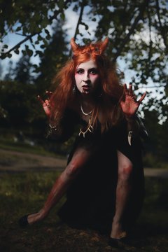 Portrait girl with red hair and bloody face vampire, murderer, psycho, halloween theme, bloody woman