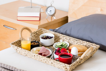 Breakfast Tray on Unmade Bed in Hotel Room