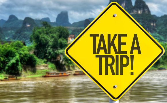 Take a Trip sign with exotic background