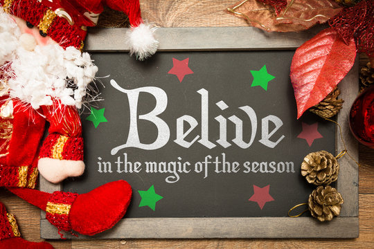 Blackboard with the text: Believe in the Magic of the Season in a christmas conceptual image
