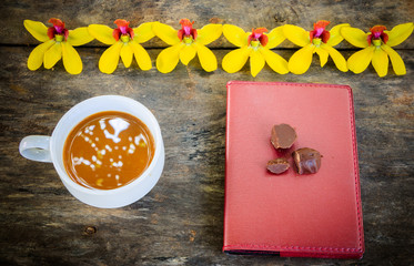 cop of coffee with notebook on old desk