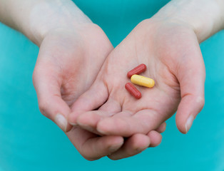 Close-up of two human hands, the hands are capsules
