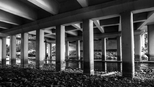 Fototapeta Grunge urban scene under automotive bridge.