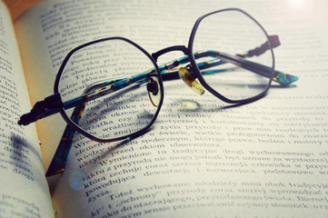 Vintage style glasses on old book