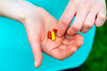Close-up of two human hands, the hands are capsules
